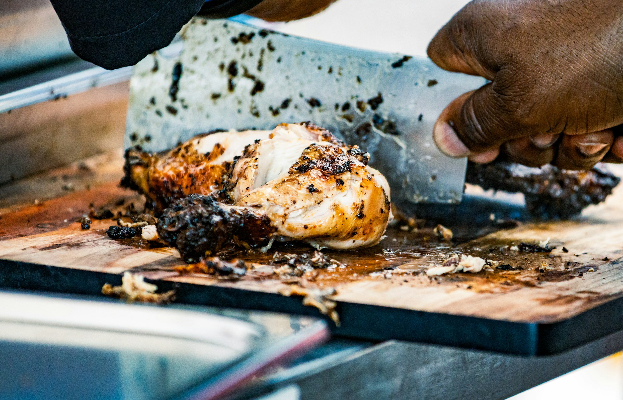 Chef preparing authentic jerk chicken with Caribbean spices